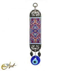 Evil Eye amulet with blue carpet background.