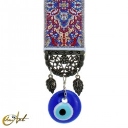 Evil Eye amulet with blue carpet background.