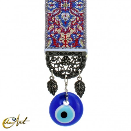 Evil Eye amulet with blue carpet background.